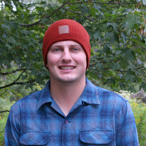 Model Wearing Adult Acrylic/Wool Beanie in Dark Orange