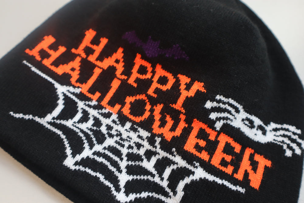 black hat with Happy Halloween saying and spider web