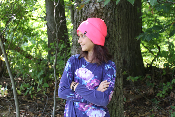 Model Wearing Child Fleece Cap in Neon Pink