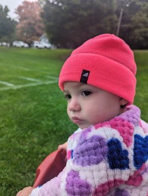 Model Wearing Infant Fleece Cap in Neon Pink