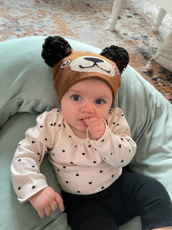 Model Wearing Infant Specialty Hat in Brown Bear Design