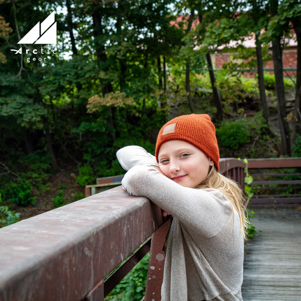Model Wearing Child Acrylic/Wool Beanie in Dark Orange