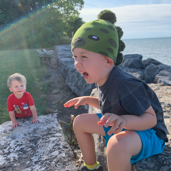 Model Wearing Child Specialty Hat in Dinosaur Design