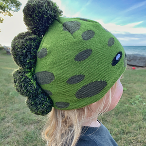 Model Wearing Toddler Specialty Hat in Dinosaur Design