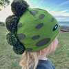 Model Wearing Toddler Specialty Hat in Dinosaur Design