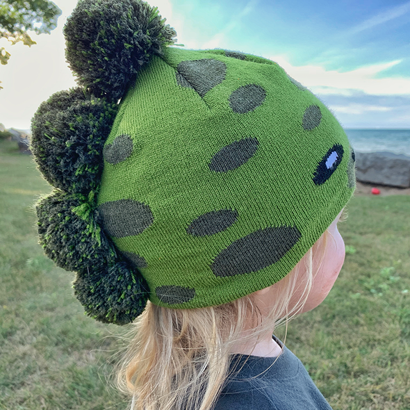 Model Wearing Toddler Specialty Hat in Dinosaur Design